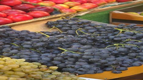 close up of a bunch of red grapes on a fruit stand