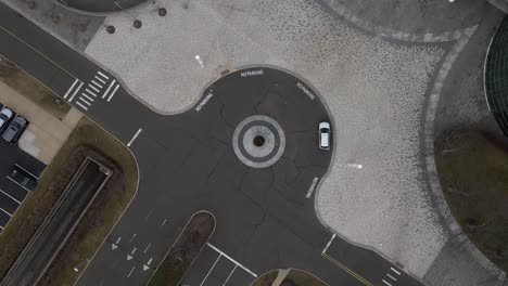 a top down view directly over an office building vehicle roundabout