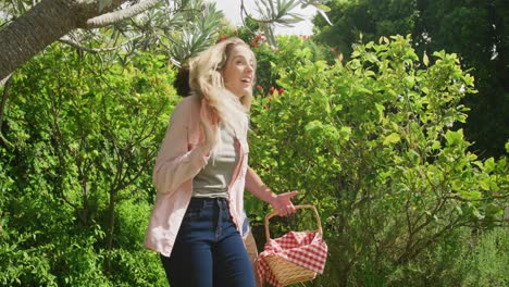 Happy-diverse-couple-walking-in-garden-on-sunny-day