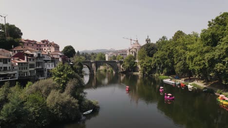 beautiful cityscape with old medieval stone bridge of amarante town, aerial drone view
