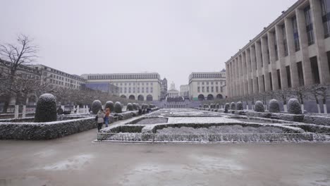 wide skyline view of the mont des arts gardens in brussels, belgium during snowy wintertime