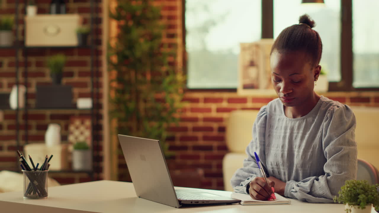 Teleworker taking notes about tasks
