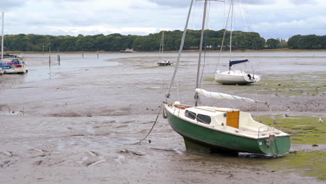 a moored boat in chichester harbour at low tide