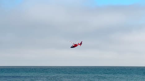 us coast guard helicopter in a training or search mission over the pacific ocean