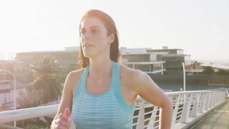 Young-woman-running-on-a-bridge