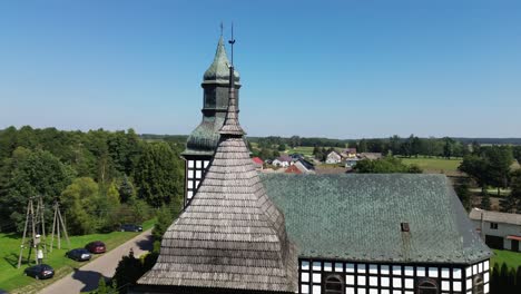 belfry roof and old half timbered church on sunny day aerial circulating