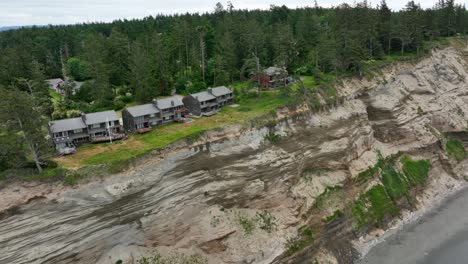 Aerial-view-of-ocean-condos-perched-on-the-edge-of-a-steep-cliffside