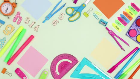 School frame made of writing stationery move on green theme with copy space. Stop motion
