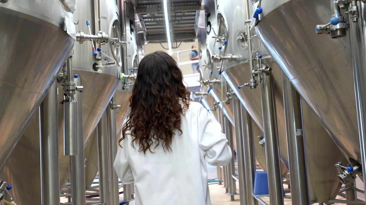 Woman in Lab Coat in a Brewery