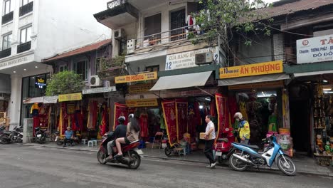 motorbikes and pedestrians on a busy street