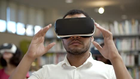 Serious-African-American-man-experiencing-new-VR-glasses