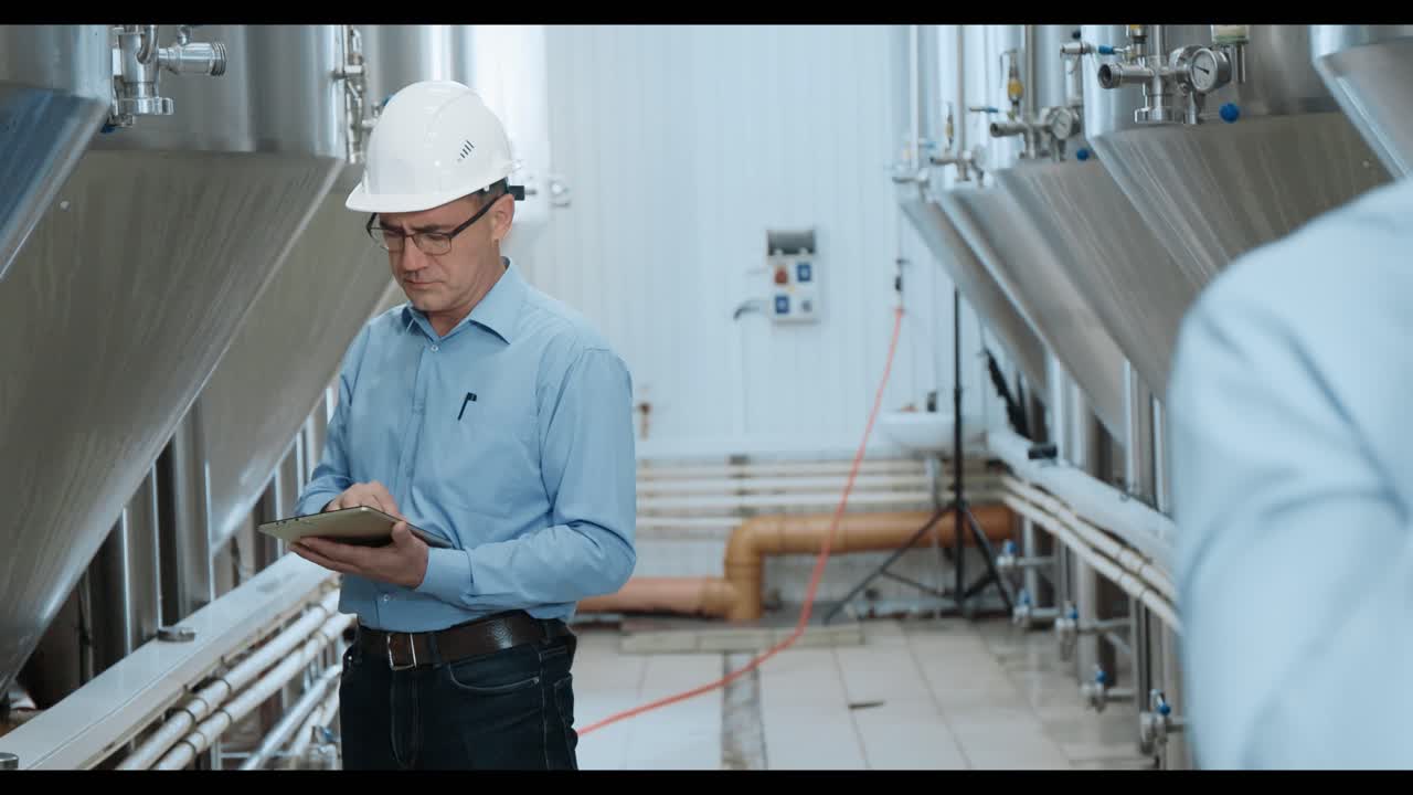 Factory Engineers Inspecting Industrial Equipment