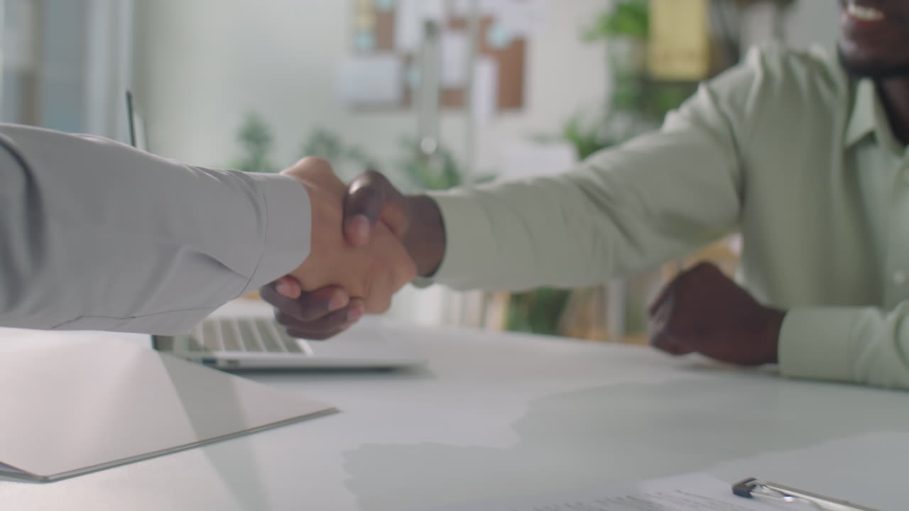 Business Partners Signing Contract and Shaking Hands