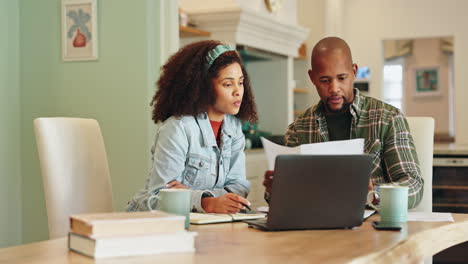 couple working on finances at home