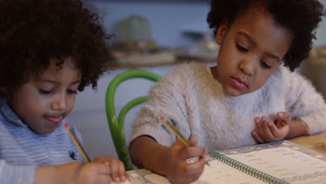 Two-Children-Doing-Homework-At-Kitchen-Table-Shot-On-R3D