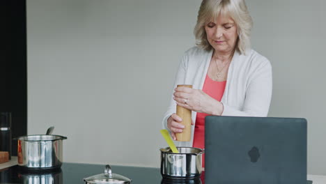 senior woman cooking a recipe in her kitchen