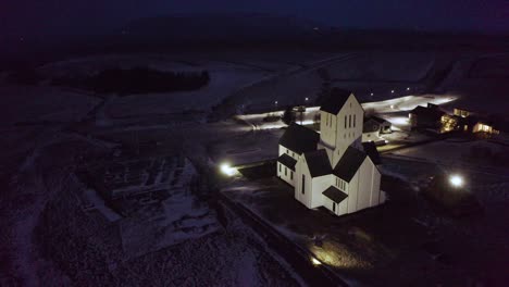 Aerial Scenic Footage of Lonely Beautiful Luminous Church In Iceland, Snowy Night