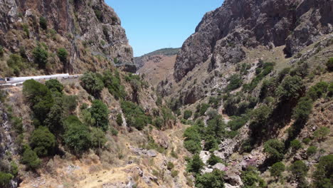 aerial view through topolia gorge, canyon road and lush mountain valley, crete, greece