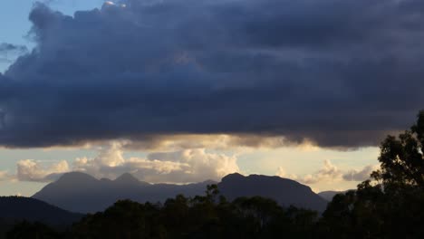 clouds moving over mountains at dusk