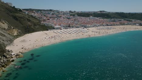 drone shot of nazaré from the sea to the beach and finished in the city