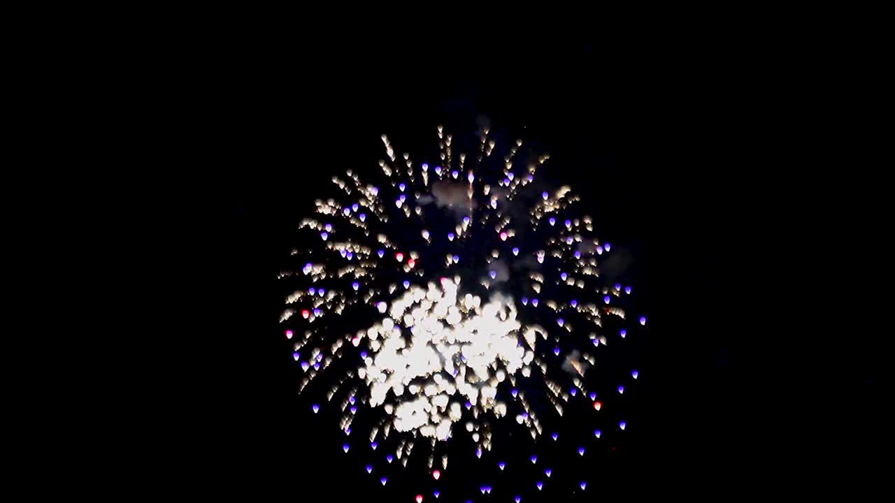 Diversi fuochi d'artificio esplodono uno dopo l'altro nello stesso punto nel cielo notturno