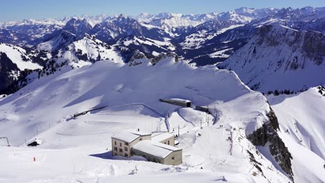 rochers de naye mountain railway summit station in the snow covered mountains of the swiss alps