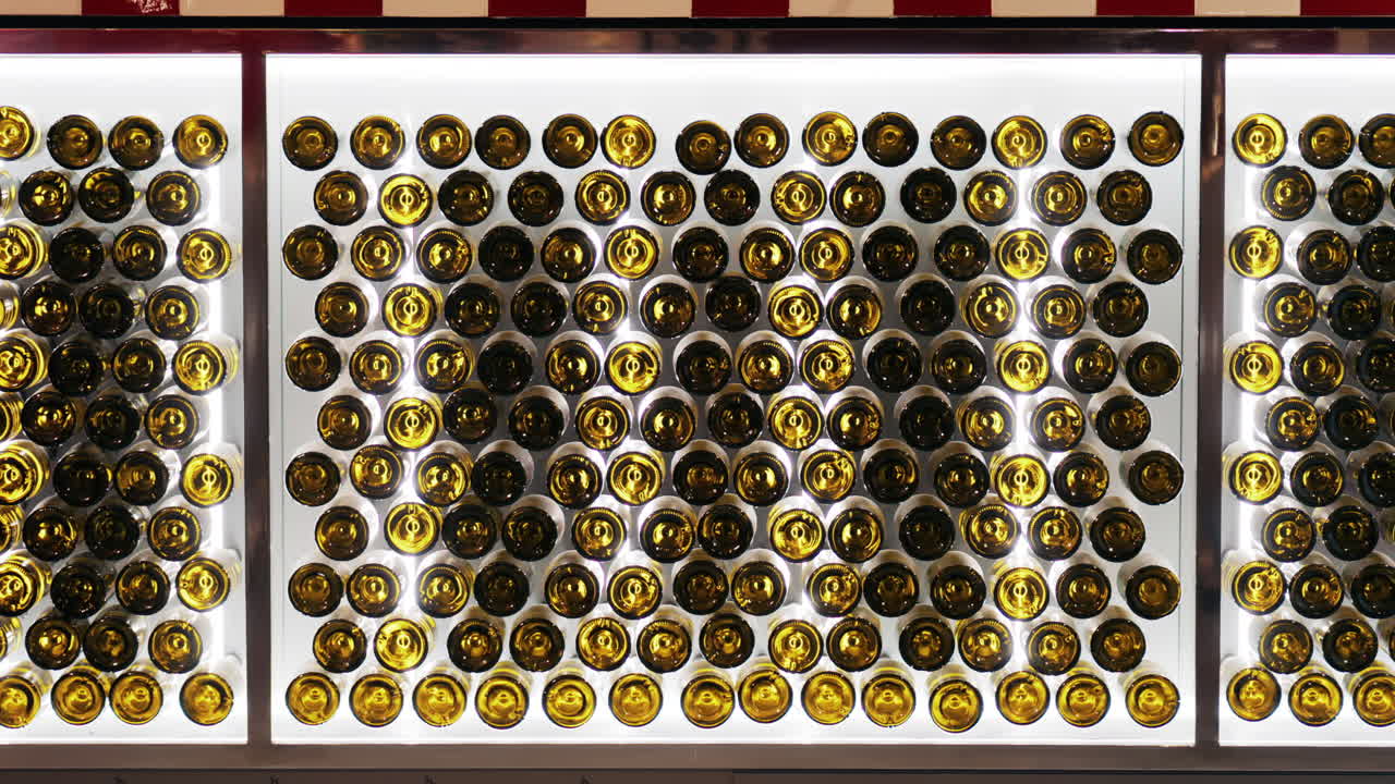 Multiple wine bottles on racks at the Chateau de Cremat winery