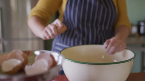 midsection of caucasian woman baking in kitchen