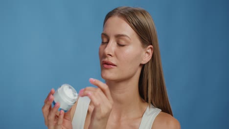 woman applying facial cream