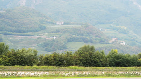 green lush landscape of north italy with mountains, static view