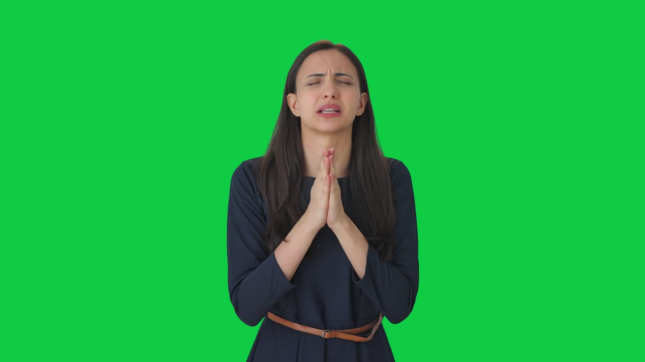 Religious Indian girl praying to God Green screen