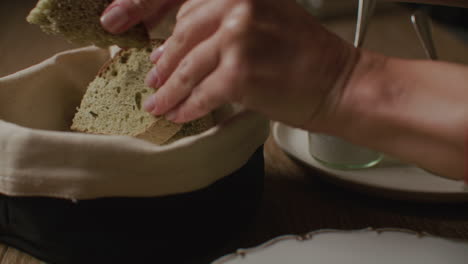person serving bread with olive oil