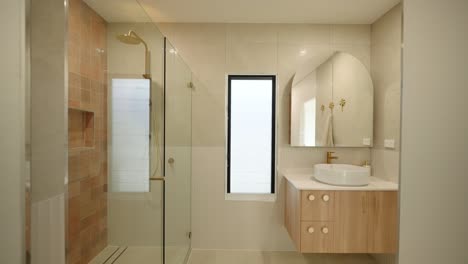 modern bathroom in a display home with clean white finishes, sleek countertops, and a spacious layout for a luxurious feel