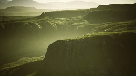 sunrise over green hills and mountains in a serene landscape