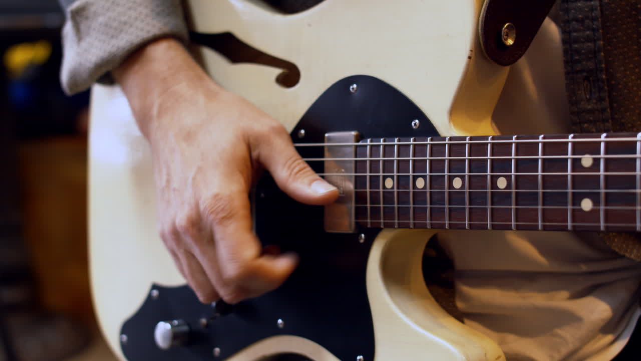 Man playing guitar close up in 4k