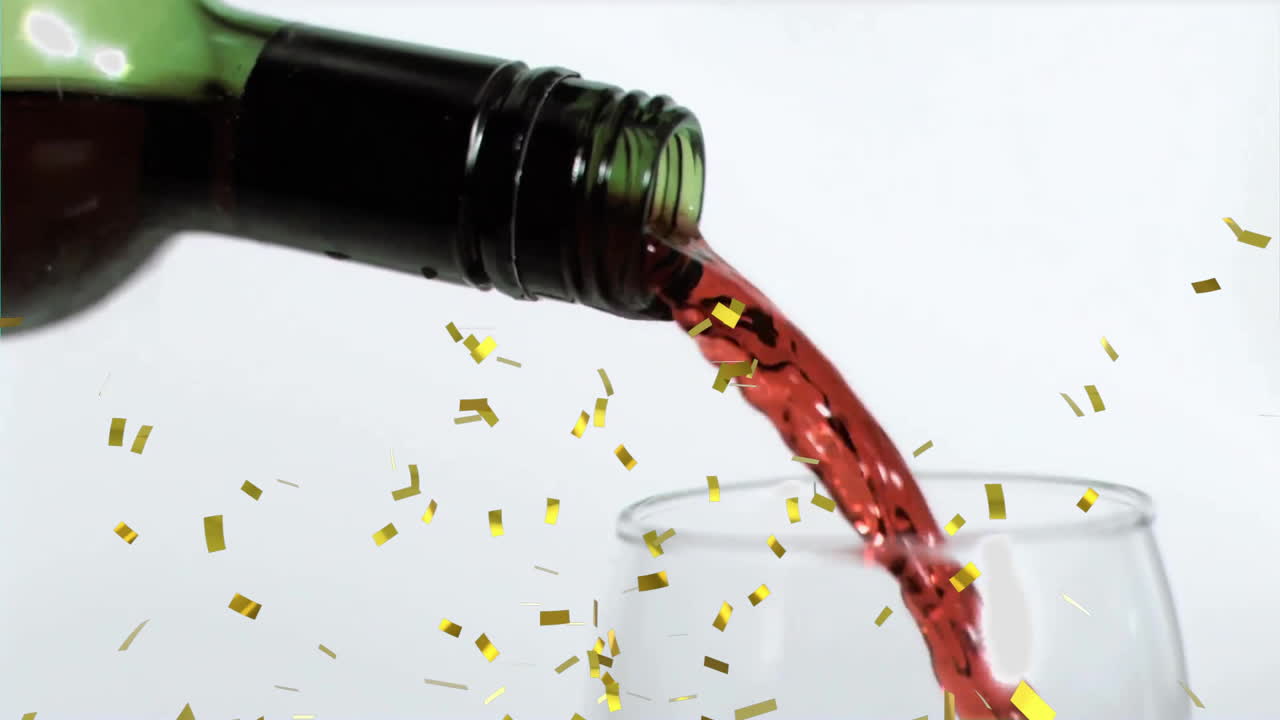 Animation of confetti over glass of red wine on white background