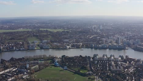 high drone shot over isle of dogs towards greenwich university and observatory