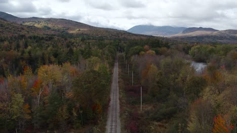 Railroad-Track-Surrounded-By-Forest-During-Fall,-New-England