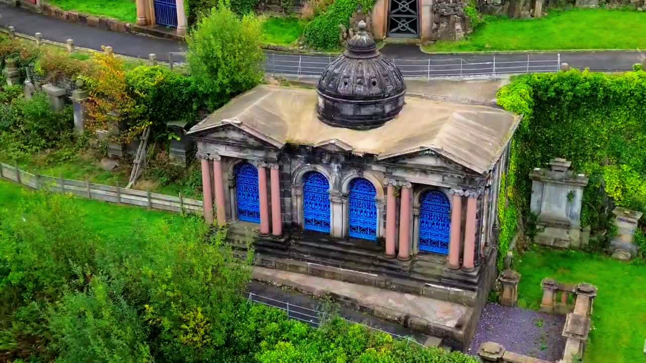 Historic domed tomb with columns at Glasgow Necropolis, Scotland, a Victorian-era cemetery and landmark of architectural significance, aerial view