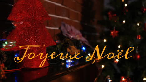 animation of joyeux noel text over christmas decorations