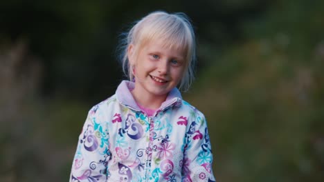 a cute kid laughs into the camera