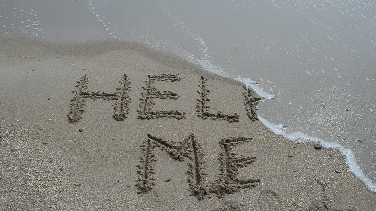 Help Sign on the sand of tropical sea beach. Shooting on the beach