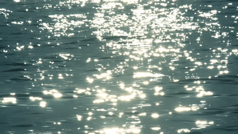 slow motion of blue sea water surface with sparks