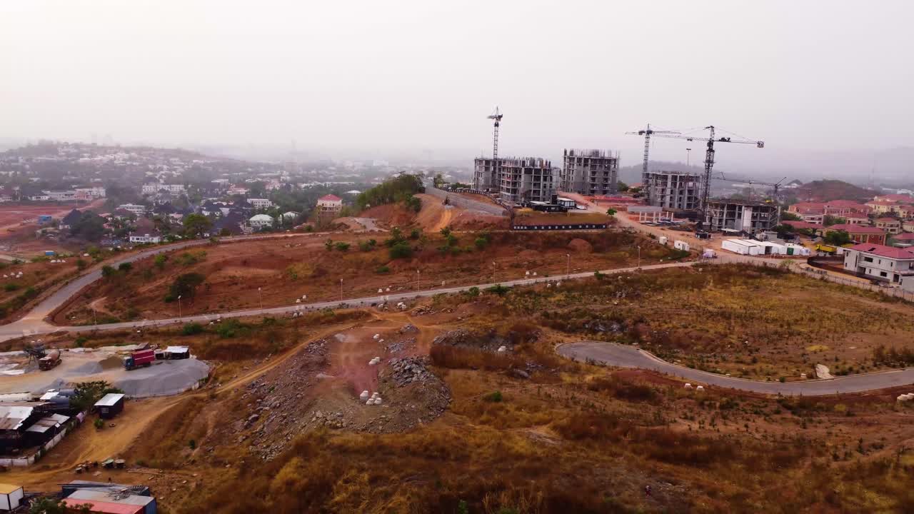 Aerial overview of an under construction highway interchange in Asokoro, Abuja, showing dirt roads and developing infrastructure, a real estate ongoing building in Nigeria, Africa