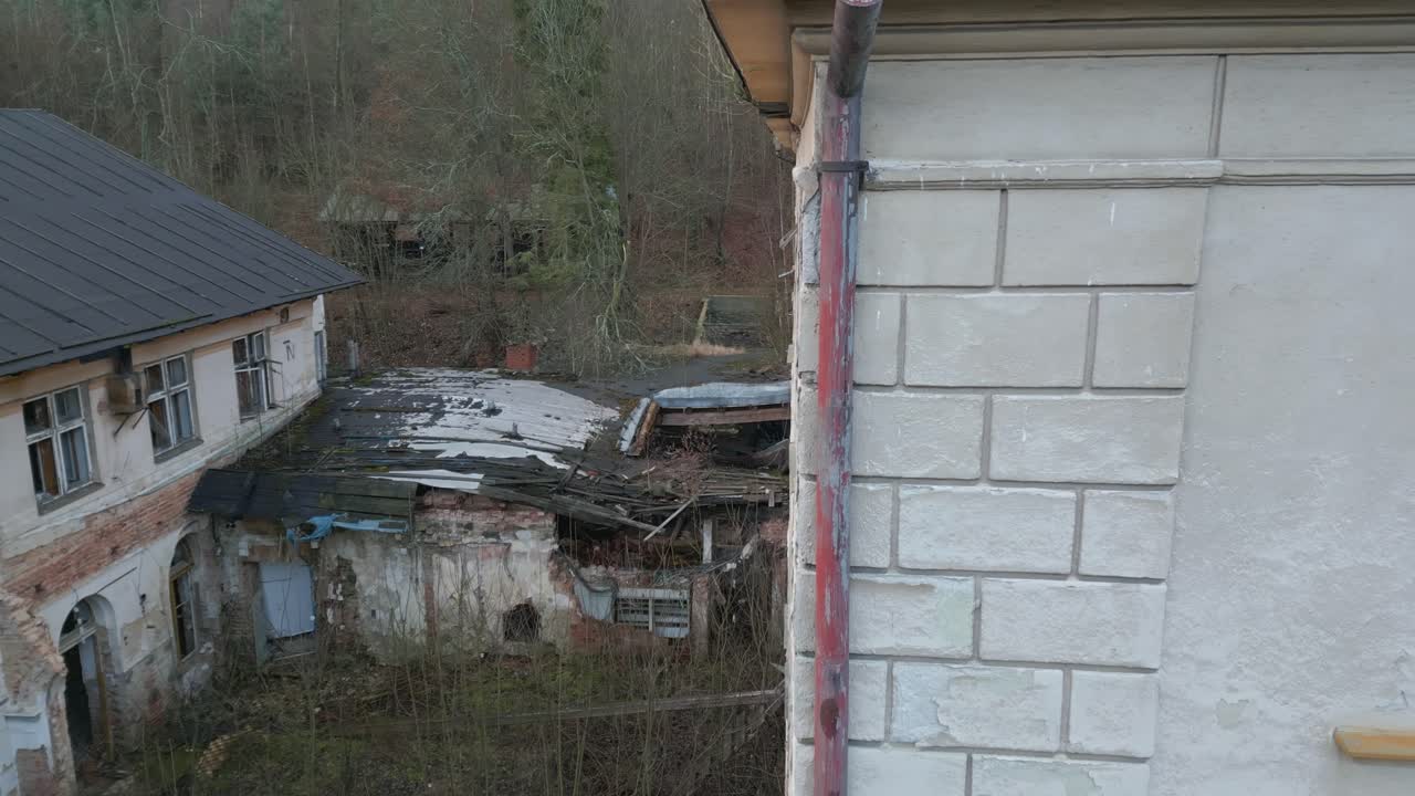 Crumbling exterior of abandoned sanitorium spa complex Janske Koupele