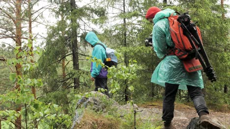 hikers with rain gear in the woods