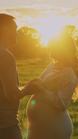 pregnant couple at sunset