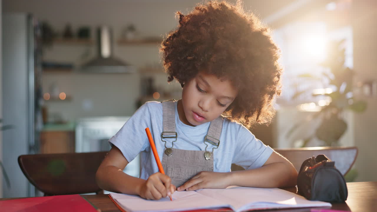A child drawing and writing at a desk