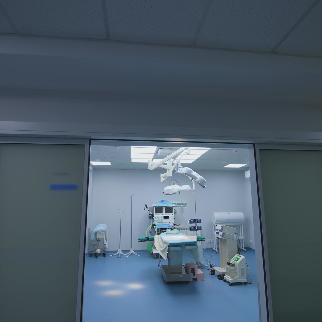 Modern intensive care unit without people. Operating theatre with medical equipment. Interior of contemporary medical room. View from the door