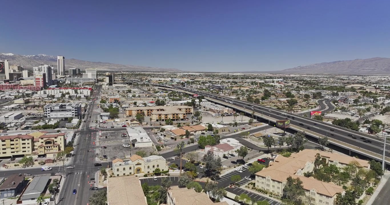 Las Vegas Nevada Aerial v197 wide flyover above downtown neighborhoods and sprawling suburbs framed by desert mountains - Shot with Mavic 3 Pro Cine - May 2nd 2024